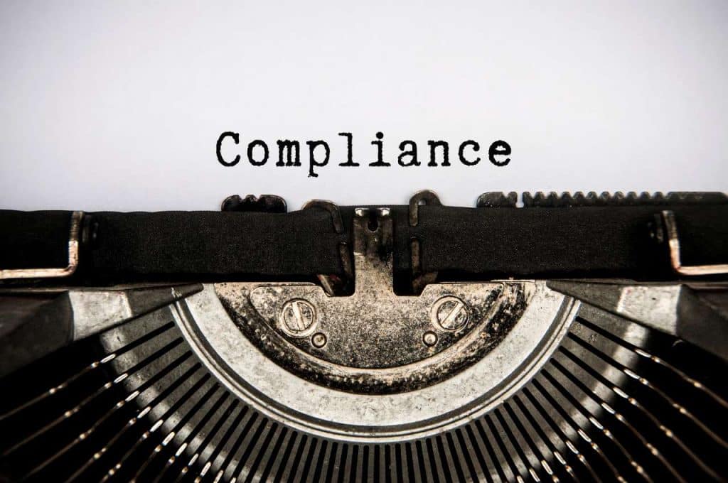Compliance text typed on an old vintage typewriter