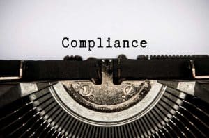 Compliance text typed on an old vintage typewriter