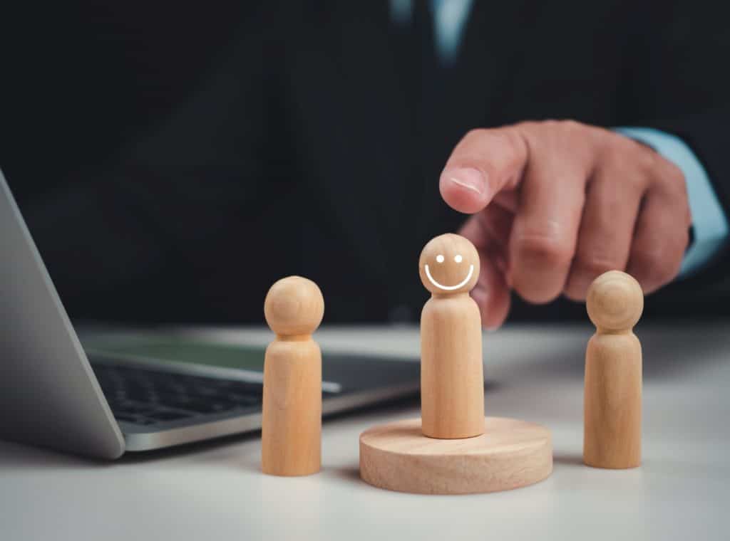 small wooden figure with smiley face